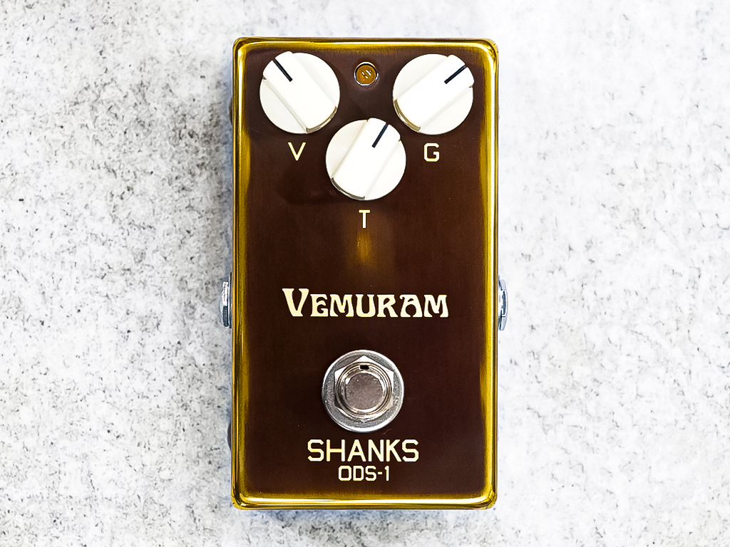 Vemuram Shanks ODS-1 overdrive pedal in a gold enclosure with volume, gain, and tone knobs and central footswitch, shown from above.