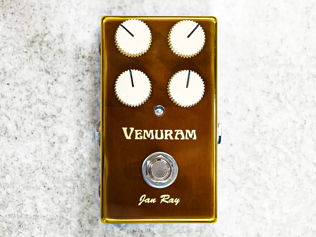 Vemuram Jan Ray overdrive guitar pedal in a gold enclosure with four white control knobs and central footswitch, viewed from above.