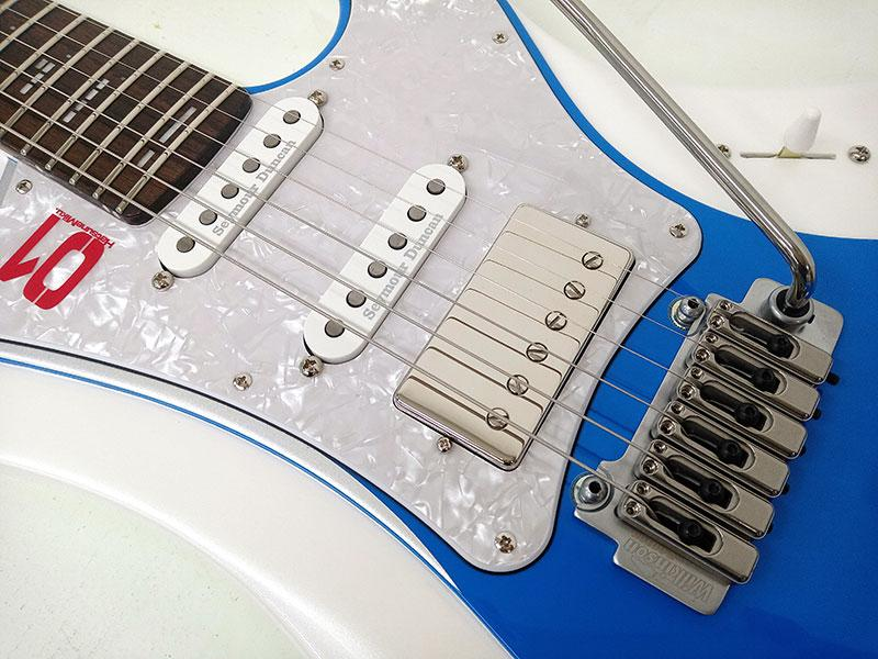 Close-up of GrassRoots G-STREAM-Miku SNOW MIKU Edition SSH pickup layout with two single-coils and one humbucker