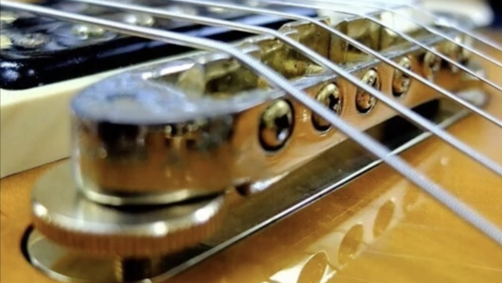 Yamaha SG2000 bridge mounted on brass sustain plate close-up