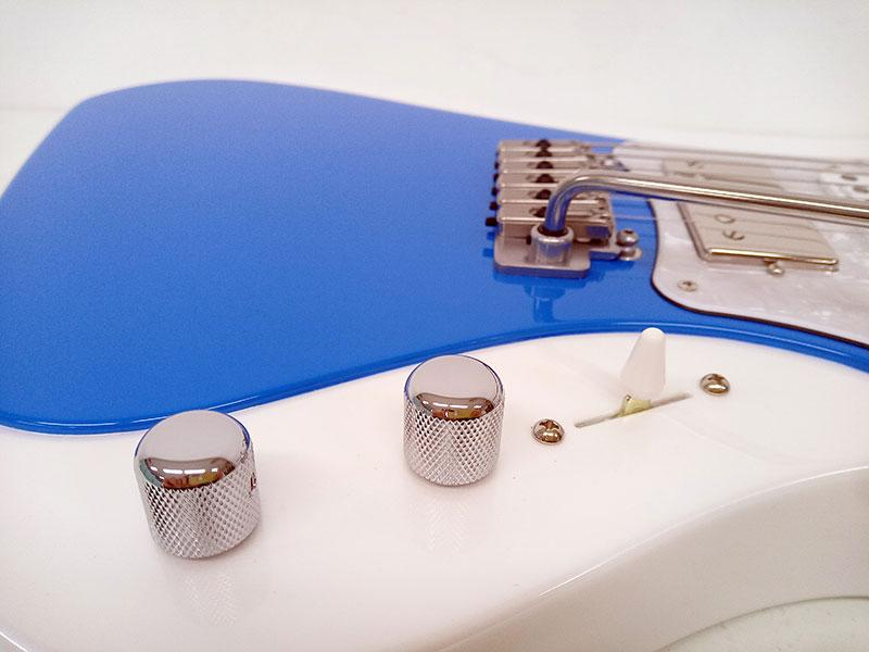 Close-up of GrassRoots G-STREAM-Miku SNOW MIKU Edition body showing white finish, blue accent, and control knobs