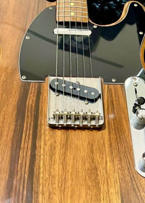 Close-up of the 6-saddle bridge on a Fender Japan TL69-98 Rosewood Telecaster with modern intonation design.
