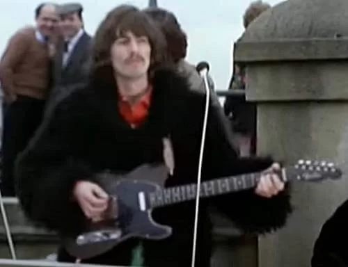 George Harrison performing with his all-rosewood Fender Telecaster during the Beatles’ rooftop concert in 1969.