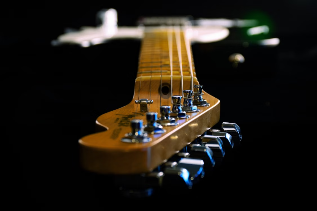Close-up view along an electric guitar neck and headstock