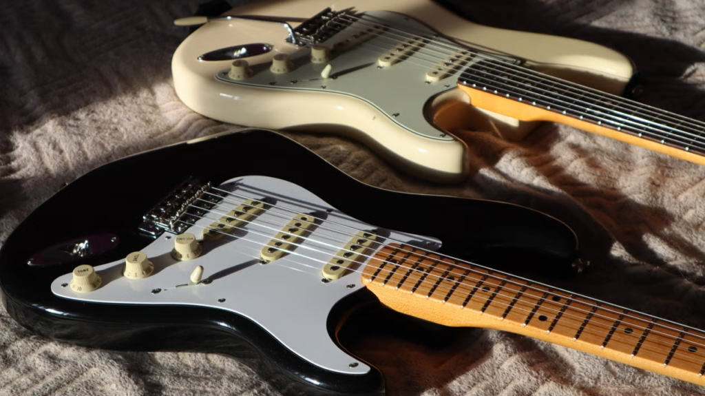 Two Strat-style electric guitars stored indoors

