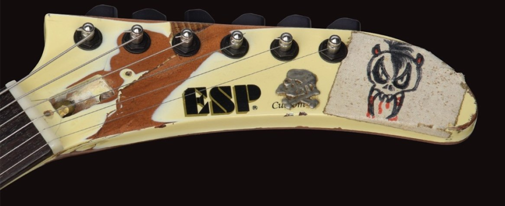 Close-up of the stickers and gaffer-tape writing on James Hetfield's ESP EET FUK guitar