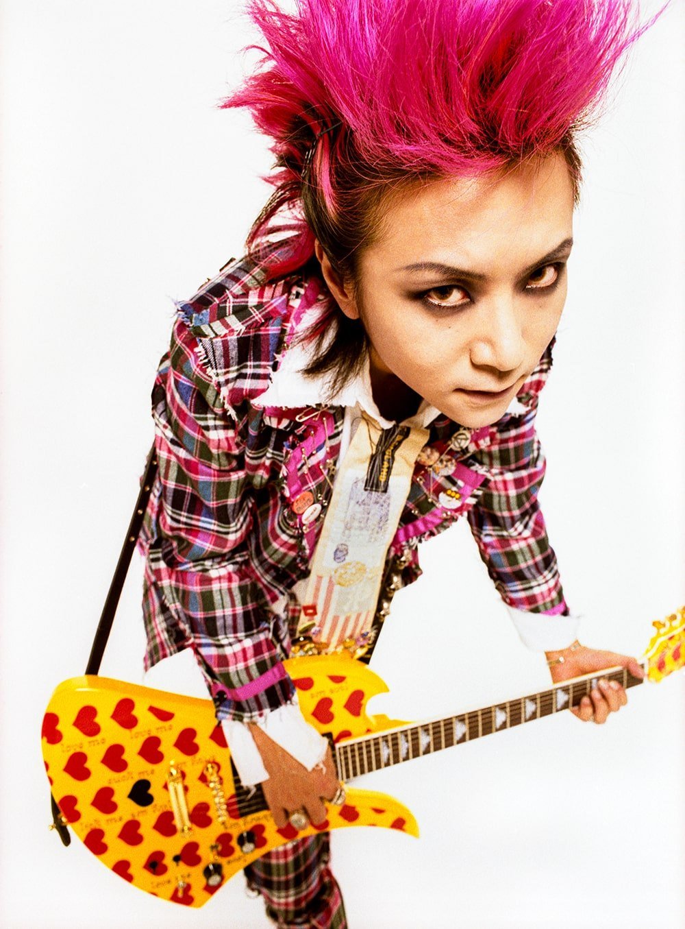 hide of X JAPAN holding his Yellow Heart Mockingbird guitar