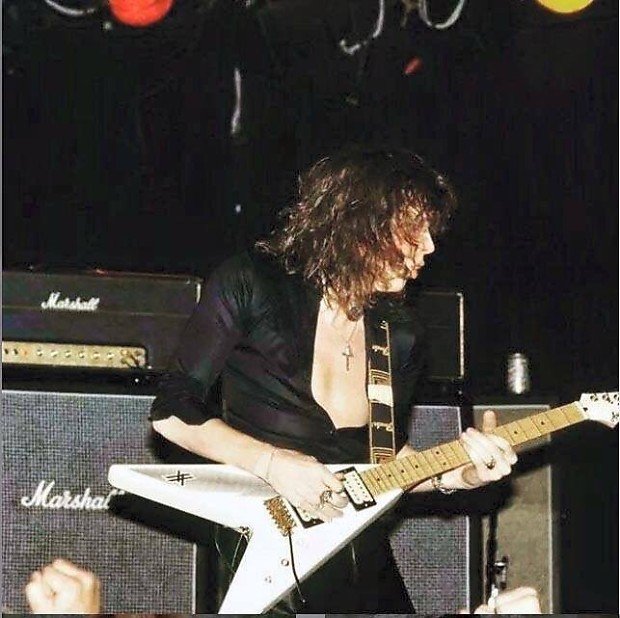Yngwie Malmsteen playing a white Aria Pro II XX with humbuckers on stage